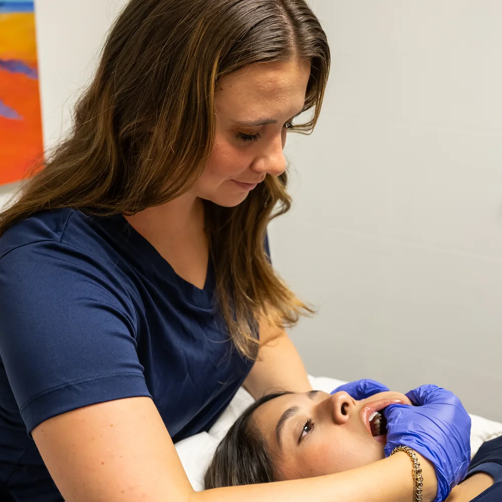 Therapist working with a client on tmj & headaches